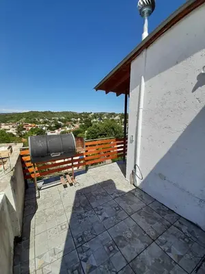 a bench sitting on a patio next to a building at Lomas De Piquillin in Villa Carlos Paz
