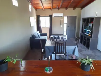 a living room with a couch and a table at Lomas De Piquillin in Villa Carlos Paz