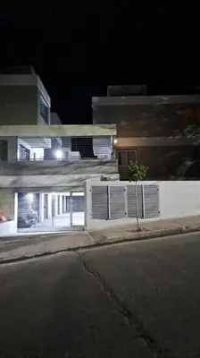 a building on the side of a street at night at La Paz 80 in Villa Carlos Paz