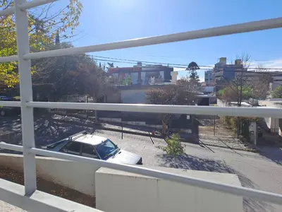 a white car parked in a parking lot at La Paz 80 in Villa Carlos Paz