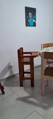 a table and a chair and a picture on a wall at La Paz 80 in Villa Carlos Paz