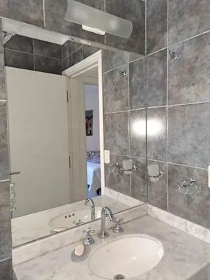 a bathroom with a sink and a mirror at La Paz 80 in Villa Carlos Paz