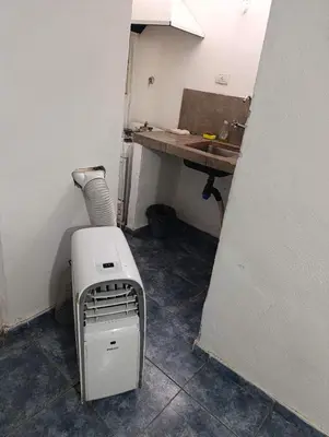 a small room with a heater and a table at EL trebol in Cordoba