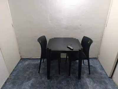 a black table with two chairs and a remote control on it at EL trebol in Cordoba