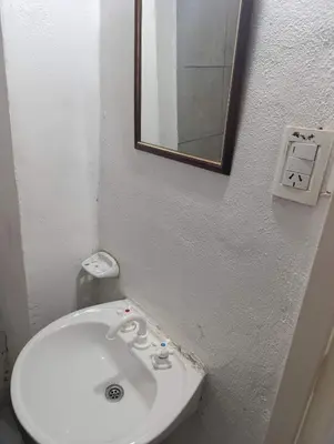 a bathroom with a white sink and a mirror at EL trebol in Cordoba