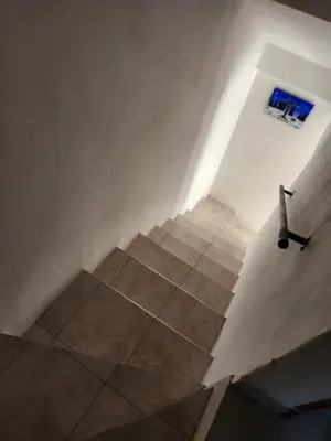 a staircase in a room with a blue window at Altos de Grecia Cabaña 3 in Villa Carlos Paz