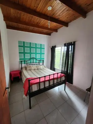 a bedroom with a large bed in a room at Altos de Grecia Cabaña 3 in Villa Carlos Paz