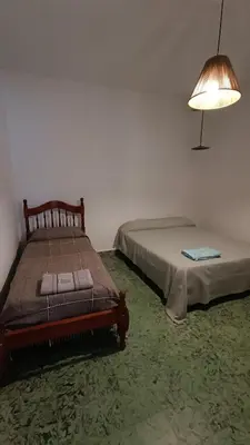 a bedroom with two beds and a lamp in it at Departamento interno in Alta Gracia