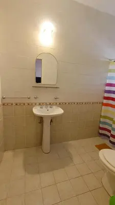 a bathroom with a sink and a mirror and a toilet at Departamento interno in Alta Gracia