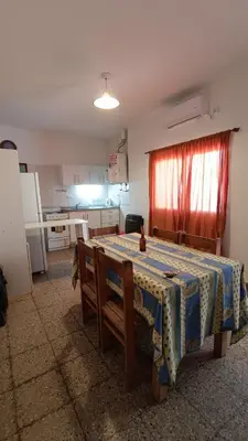 a room with a table and a kitchen with a table and a table at Departamento interno in Alta Gracia