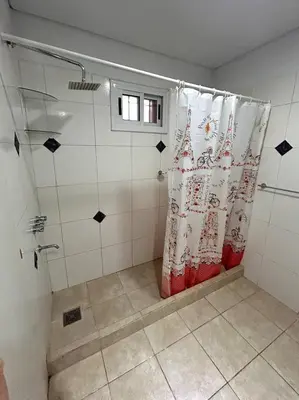 a shower with a shower curtain in a bathroom at Departamento Cerro Overo in Merlo