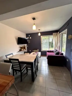 a living room with a table and a couch at Departamento Cerro Overo in Merlo
