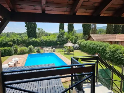 a view of a swimming pool from a balcony at Departamento con pileta cerca del centro in Villa General Belgrano