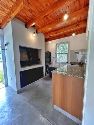 a kitchen with a center island in a room at Casa Longoseiros in Merlo