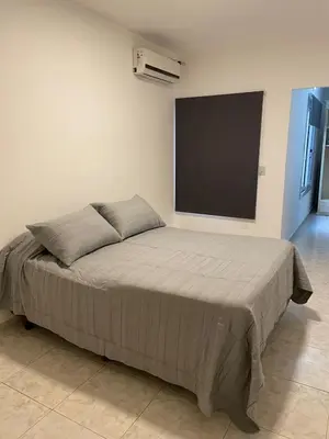 a bed in a room with a flat screen tv at Torre Kalinka dos dormitorios pleno centro in Villa Carlos Paz