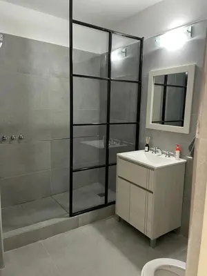 a bathroom with a shower and a sink and a toilet at Torre Kalinka dos dormitorios pleno centro in Villa Carlos Paz