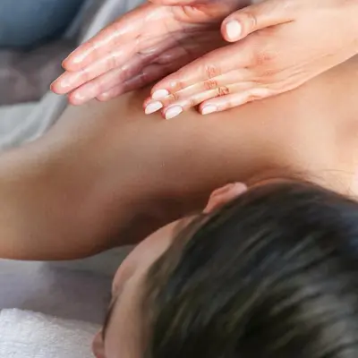 a woman with her hands on the back of a child at Berna Hotel & Spa in Villa General Belgrano