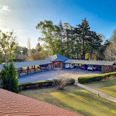 a building with a tent in a park at Berna Hotel & Spa in Villa General Belgrano