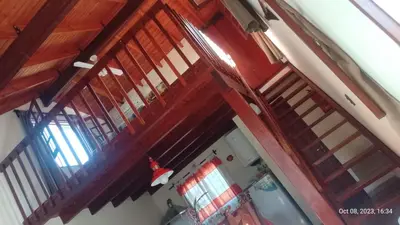 an overhead view of a room with wooden rafters at Posada del Arroyo in Las Rabonas