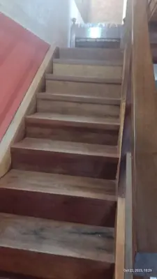 a set of wooden stairs in a room at Posada del Arroyo in Las Rabonas