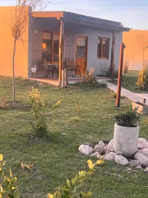 a small house with a table and chairs in a yard at Ranchos de la Tata in Las Calles