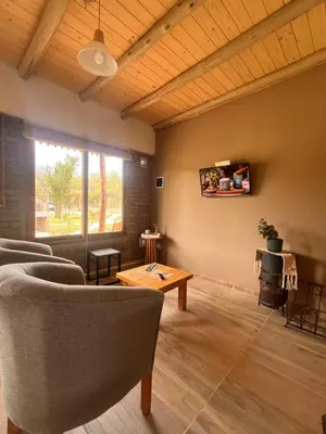 a living room with chairs and a table at Ranchos de la Tata in Las Calles
