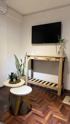 a living room with a table with a tv on it at Departamento en Nueva Cordoba in Cordoba