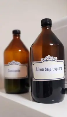 two bottles of honey sitting on a refrigerator shelf at Departamento en Nueva Cordoba in Cordoba