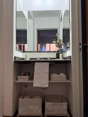 a bathroom with a sink and a mirror at Departamento en Nueva Cordoba in Cordoba