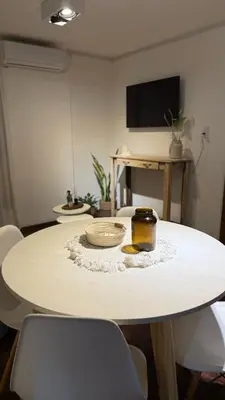a white table with two bowls on top of it at Departamento en Nueva Cordoba in Cordoba