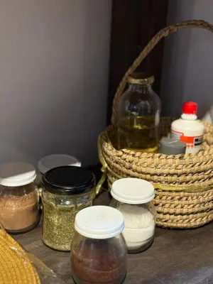 a table with jars and a basket of spices at Departamento en Nueva Cordoba in Cordoba
