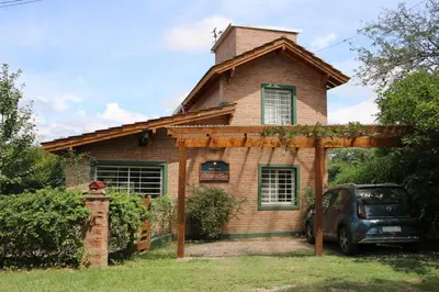 a house with a car parked in front of it at Viento Sur in Villa General Belgrano