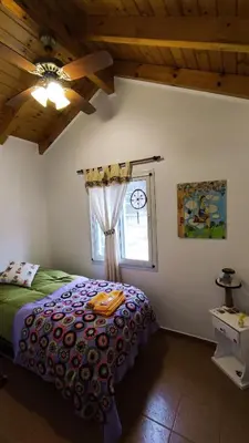 a bedroom with a bed and a window at Viento Sur in Villa General Belgrano