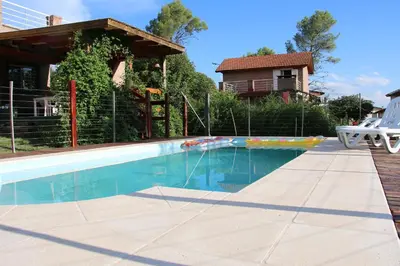 a swimming pool in front of a house at Viento Sur in Villa General Belgrano