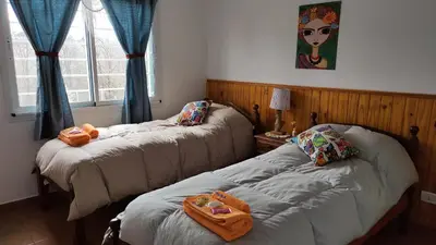 a room with two beds with towels on them at Viento Sur in Villa General Belgrano