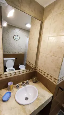 a bathroom with a sink and a toilet at Viento Sur in Villa General Belgrano