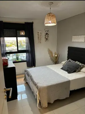 a bedroom with a bed and a chandelier at Departamento en general Paz a pocas cuadras del panal in Cordoba