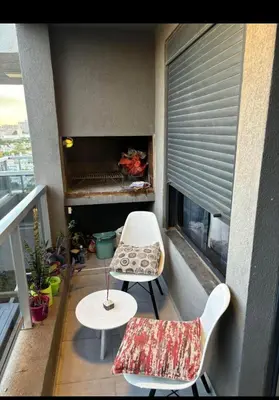 a balcony with a table and chairs and a fireplace at Departamento en general Paz a pocas cuadras del panal in Cordoba