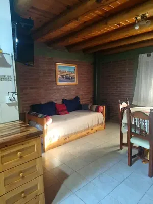 a bedroom with a bed in a brick wall at TIERRA SERRANA CABAÑAS s in Villa Anizacate