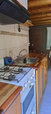 a kitchen with a stove and a sink at TIERRA SERRANA CABAÑAS s in Villa Anizacate
