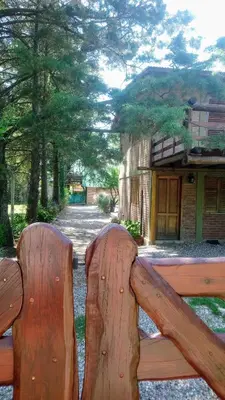 a wooden park bench with the back of it at TIERRA SERRANA CABAÑAS s in Villa Anizacate