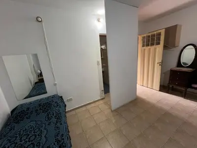 a bedroom with a mirror and a bed in a room at Monoambiente NONA in Villa Cura Brochero