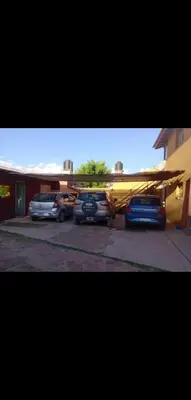 a plane parked in a parking lot next to a building at Monoambiente NONA in Villa Cura Brochero