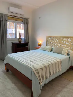 a bedroom with a large bed and a window at Clomplejo MUNAY con piscina y parking in Villa Cura Brochero