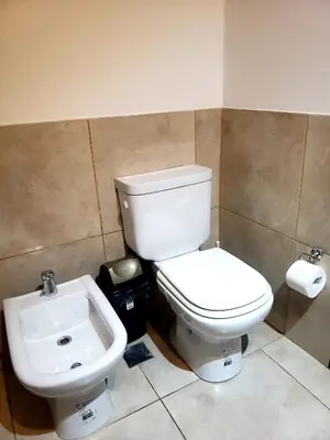 a bathroom with a toilet and a sink at Departamento en Barrio General Paz calle Güemes in Cordoba