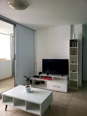 a living room with a tv and a table at Departamento en Barrio General Paz calle Güemes in Cordoba