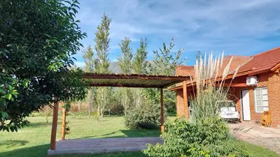 a wooden archway in front of a house at Brisa de los Molles in Los Molles