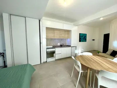 a kitchen and dining room with a table and chairs at NueveSesenta Loft in Cordoba