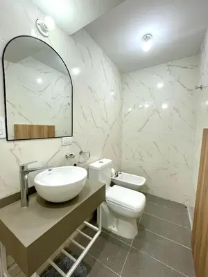 a bathroom with a sink and a toilet and a mirror at NueveSesenta Loft in Cordoba