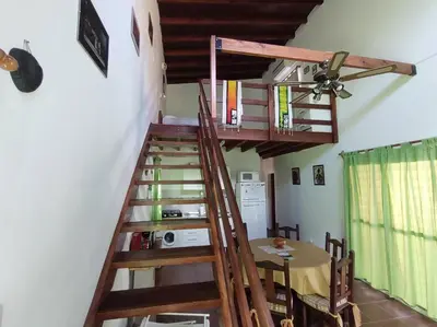 a wooden staircase leading up to a room with a table at Cabaña Sombra Lunar en Cabañas Encuentro in Carpintería